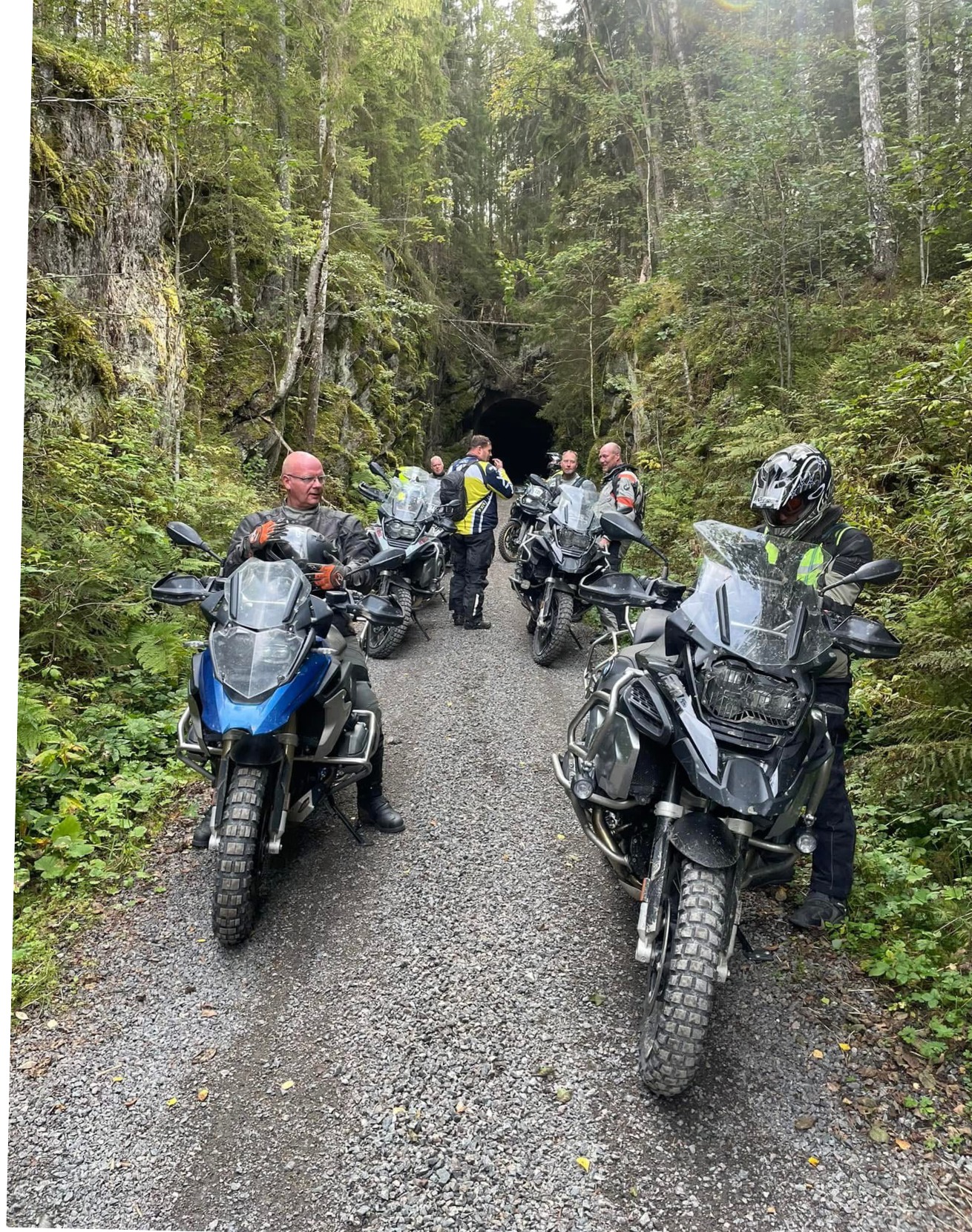 Adventure motorcycles on a gravel road in the forest
