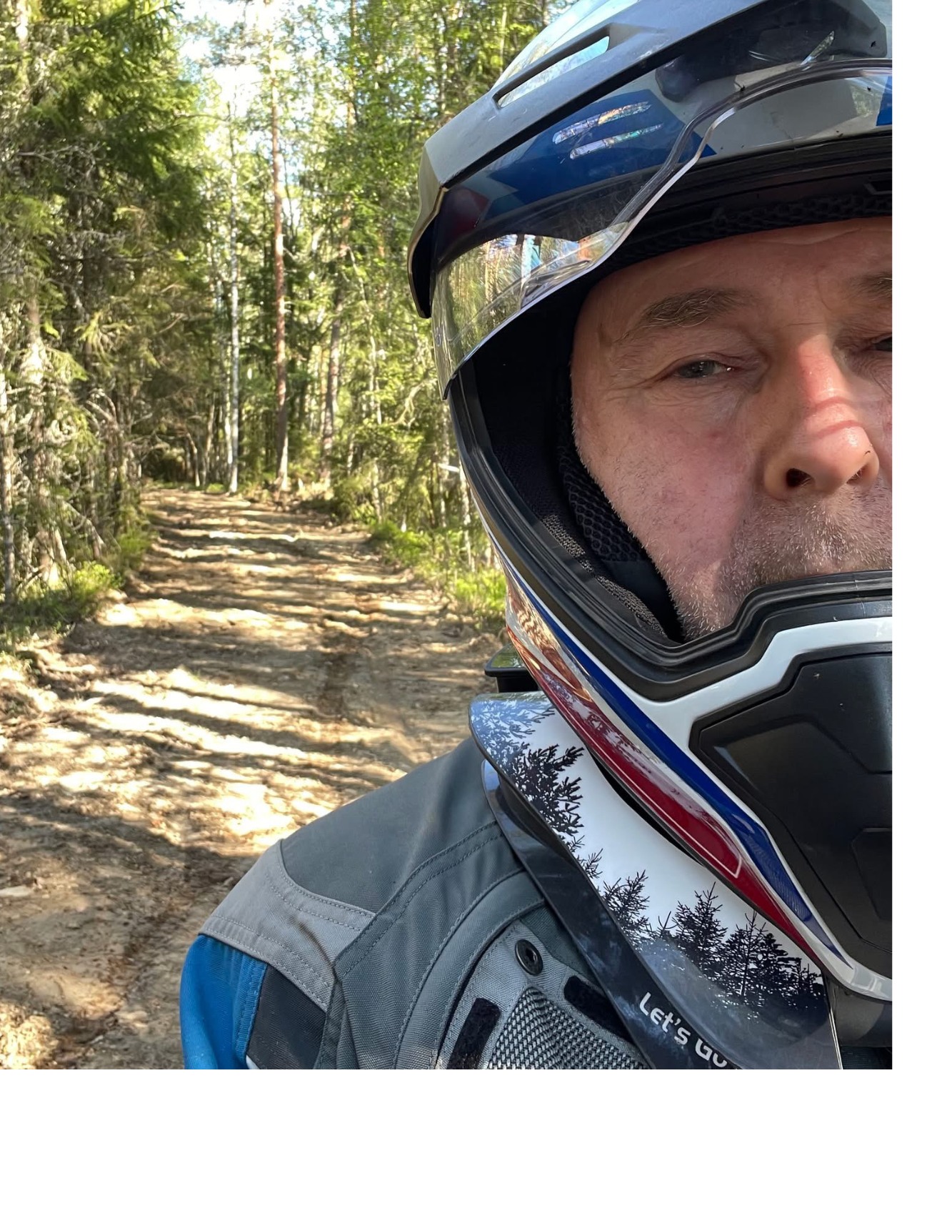 Adventure rider on a forest trail